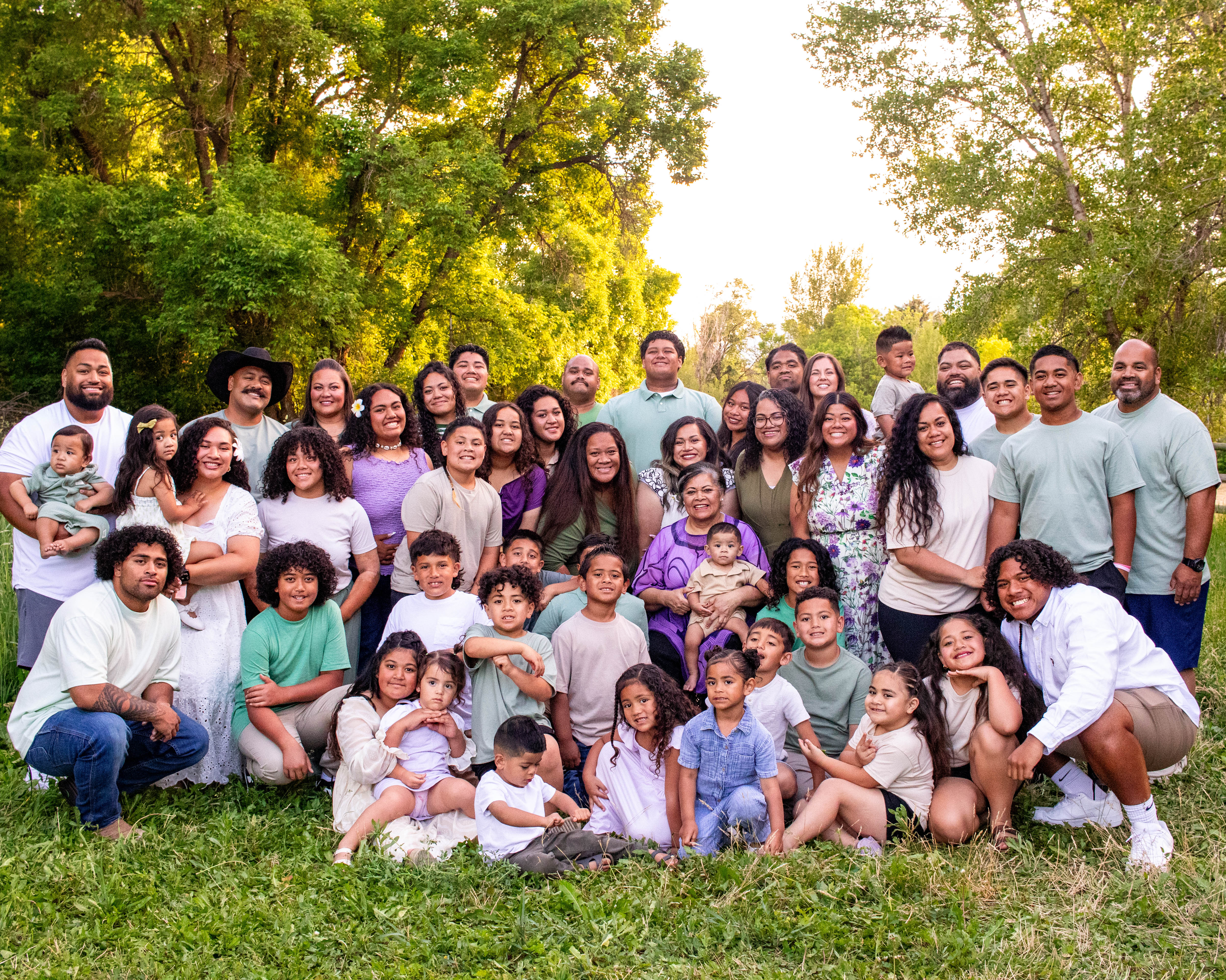 The Pauni family gathered together under the trees